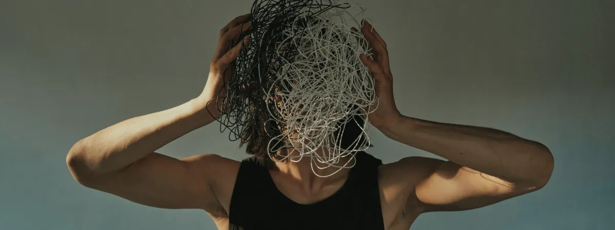 A person with a tangle of scribbled lines over their head
