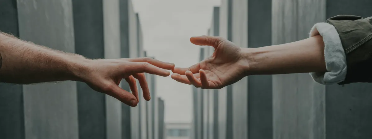 Two hands reaching towards each other